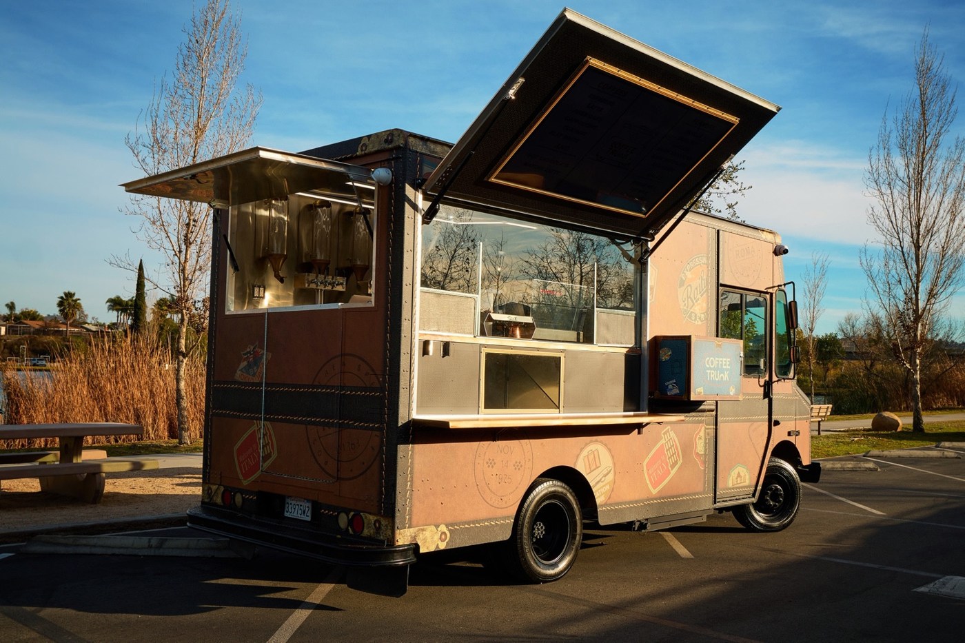 Coffee Trunk’s brown vintage luggage-inspired truck with its service windows open